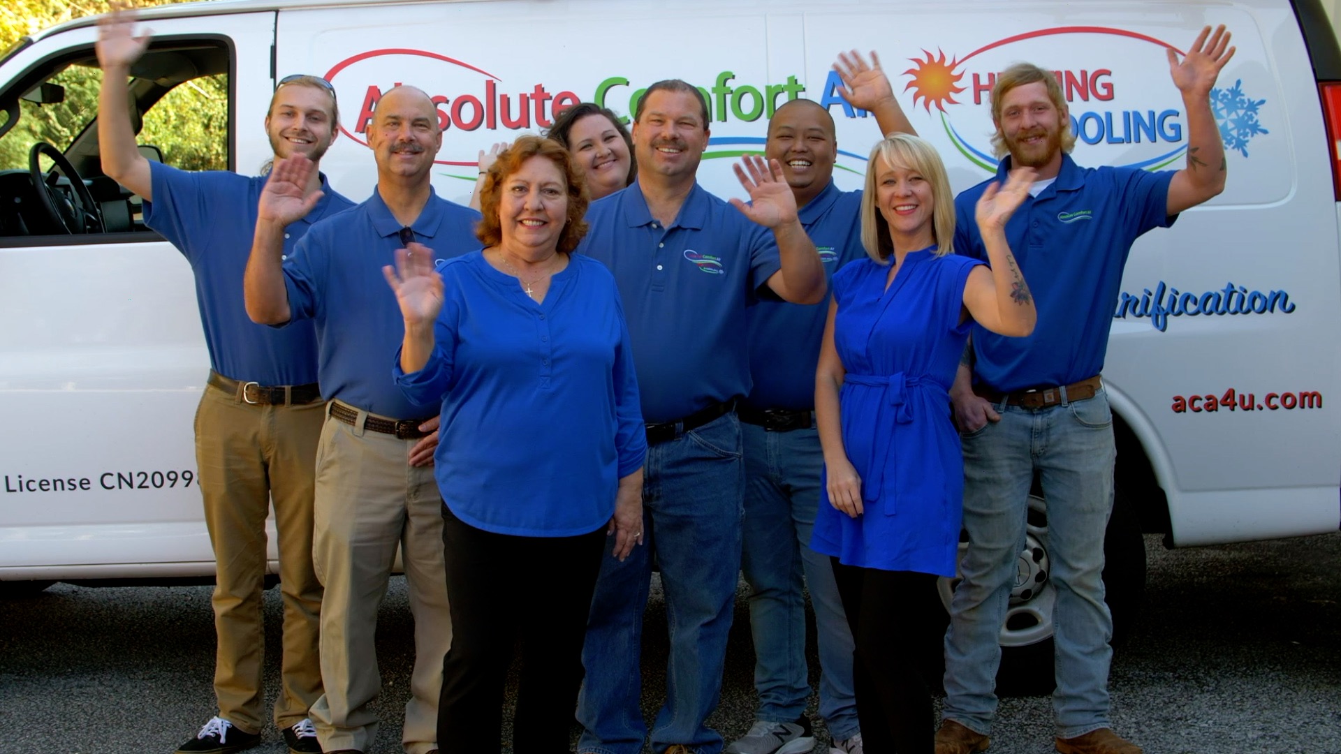 absolute comfort air team smiling and waving for a group picture